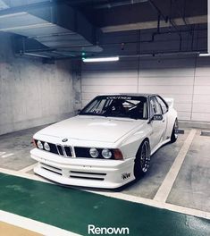 a white car parked in a parking garage