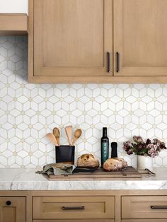 a kitchen counter topped with wooden cabinets and cooking utensils