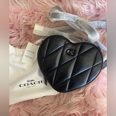 Spread Love Wherever You Go With This Fabulous Quilted Leather Heart Crossbody By Coach. Description: Style Id: Ce725 Color: Pewter/Black Mini Sized Bag; 7-1/2"W X 6-1/2"H X 2-1/4"D (Width Is Measured Across The Bottom Of Handbag) Silhouette Is Based Off 5'9" Model 23"L Detachable Strap Zip Closure Silver-Tone Exterior Hardware & Logo 1 Interior Credit Card Slot Bag Converts From Crossbody To Clutch By Removing Strap Polished Pebble Leather; Trim Signature Coated Canvas (Cotton/Polyester) Profes Chic Black Bag For Valentine's Day, Elegant Leather Bags For Valentine's Day, Chic Coach Shoulder Bag As Gift, Chic Leather Bag For Valentine's Day, Chic Coach Shoulder Bag For Gift, Elegant Leather Shoulder Bag For Valentine's Day, Chic Coach Shoulder Bag Gift, Luxury Coach Bags For Valentine's Day, Coach Heart Bag Black