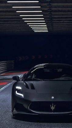 a black sports car driving through a tunnel