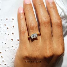 a woman's hand with a diamond ring on it