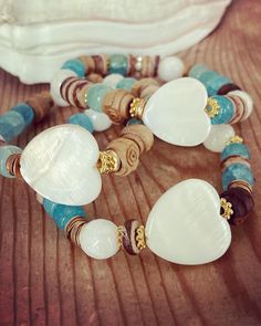 ✨ReLeasing 3 Sea DiPPerS bracelets inspired by my love of the Salt LiFe.  Luminous aqua beads are giving sea glass vibes, shimmering white mother of pearl hearts  combined with rustic vintage wooden rosette rosary beads are giving sand and washed sun vibes.  I have created two other coordinating bracelets to create the sea dipper stack. ✨ bracelets are made to fit a 6.5" wrist unless otherwise requested make your choice from drop down from one sea dipper only or the entire stack as shown in the 2nd photo. message with questions shipping is ground tracked insured White Gemstone Beads Bracelets For Beach, White Natural Stones Bracelets For Beach, White Natural Stones Bracelets For The Beach, Ocean-inspired White Bracelet As Gift, Ocean-inspired White Bracelet Gift, Turquoise Heart Beads Bracelet For Beach, Bohemian Heart Beads Bracelet For Beach, White Round Beads Ocean-inspired Bracelets, White Ocean-inspired Round Bead Bracelets