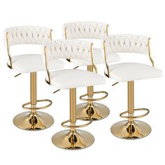 three white leatherette bar stools with gold metal base and foot rest, set of 4