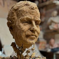 a clay sculpture of a man's head is shown