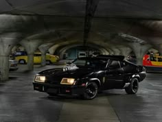 a black car parked in a parking garage