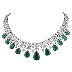 The necklace is meticulously crafted from 18 karat white gold, chosen for its luxurious appearance and durability. The white gold setting perfectly complements the emerald and diamonds, creating a harmonious fusion of elegance and strength. The intricate detailing and craftsmanship are evident in every aspect of the necklace, showcasing the artisan's skill and expertise. Item Code :- CN-24662 Gross Wt. :- 61 gm 18k Solid White Gold Wt. :- 48.18 gm Natural Diamond Wt. :- 24.3 Ct. ( AVERAGE DIAMON Formal White Gold Emerald Necklace With Jewels, Elegant White Gold Emerald Necklace With Jewels, Elegant White Gold Emerald Necklace, Luxury Diamond Bridal Necklace With Gemstone, Formal Emerald Diamond Necklace In White Gold, Luxury Bridal Necklace With Diamond Gemstone, Luxury White Gold Emerald Diamond Necklace, Formal White Gold Emerald Diamond Necklace, Luxury White Gold Emerald Necklace With Diamond Accents