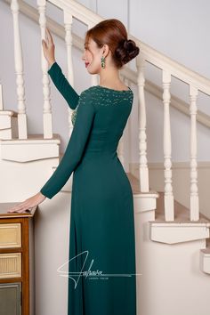 This floor length dress features a beautiful moss green fabric color, adorned with intricate beaded patterns. Its elegant design exudes sophistication and style, making it the perfect choice for any formal occasion. Elevate your wardrobe with this timeless piece.