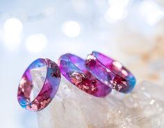 A beautiful blue and Fuschia faceted resin ring with pink metallic flakes inside. Both blue and Fuschia tone resins are beautifully mixed to create this pretty and elegant ring. This resin ring is perfect for stacking! It's faceted all the way around and it is so comfortable to wear. All my resin rings are handmade with self-made molds. they are also hand-sanded and polished, to be smooth and comfortable to wear. Given the nature of the resin, my rings may contain tiny bubbles and imperfections, Handmade Elegant Resin Rings, Elegant Handmade Resin Rings, Unique Resin Crystal Ring Gift, Handmade Resin Jewelry For Weddings, Pink Resin Ring Jewelry, Unique Resin Rings For Gifts, Purple Round Resin Jewelry, Handmade Resin Rings As A Gift, Unique Pink Promise Ring Jewelry