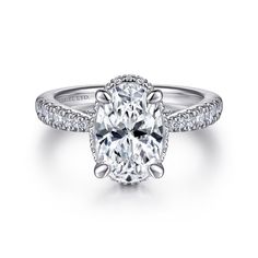 an oval cut diamond ring with pave set shoulders