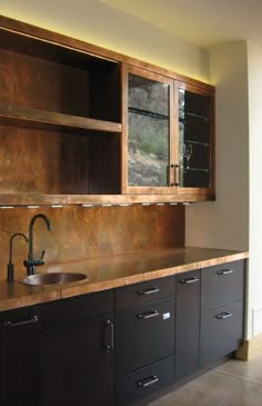 a kitchen with wooden cabinets and a sink in front of the counter top is shown