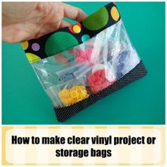 a bag filled with lots of different colored plastic bags on top of a green table