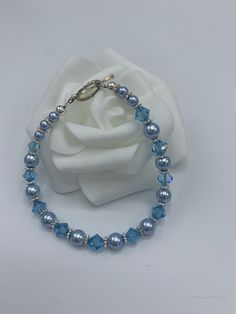 "Handcrafted light blue bracelet perfect for bridesmaids or as the bride's \"something blue\". Made from Swarovski crystals, Swarovski pearls, and .925 sterling silver.  If purchasing for a group, please send us a message and we can discuss a discount.  Sizes: 6.5\" - Petite, X-Small 7.0\" - Small 7.5\" - Medium 8.0\" - Large (For further help with sizing or custom sizing requests, send us a message. We can do children's sizes as well.)" Blue Crystal Bracelets For Wedding, Blue Crystal Bracelets For Anniversary, Adjustable Blue Crystal Bracelet For Anniversary, Blue Round Bead Bracelets For Weddings, Blue Round Beads Bracelet For Wedding, Adjustable Blue Crystal Bracelet For Wedding, Elegant Adjustable Light Blue Crystal Bracelet, Adjustable Blue Beaded Bracelets For Wedding, Elegant Light Blue Adjustable Crystal Bracelet