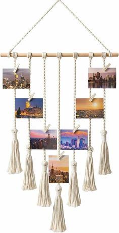 a hanging photo frame with tassels and pictures on it's sides in white