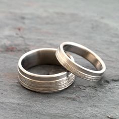 two wedding rings sitting on top of each other