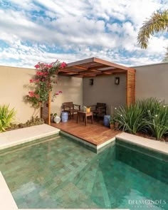 an image of a house with a pool in the middle and some plants around it