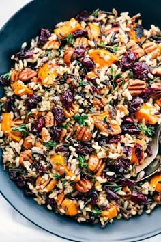 a bowl filled with rice, carrots and raisins