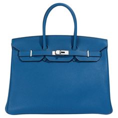 In 1984, Hermès CEO Juan-Louis Dumas boarded a flight and sat beside Jane Birkin. As she stowed away her straw handbag, the contents fell to the floor. As Birkin gathered her belongings, she explained to Dumas that she had not been able to find a leather weekend bag that she liked. It was this series of events that led Dumas to design the Birkin Bag. Almost 40 years later, the Birkin bag is world-renowned for its quality craftsmanship and intricate detailing. This jaw-dropping Hermès Birkin 35cm Blue Epsom Leather Bag With Gold-tone Hardware, Blue Epsom Leather Top Handle Bag, Luxury Blue Epsom Leather Bag, Classic Blue Bags With Silver-tone Hardware, Blue Epsom Leather Rectangular Bag, Blue Rectangular Epsom Leather Bag, Rectangular Blue Epsom Leather Bag, Luxury Blue Satchel With Palladium Hardware, Blue Rectangular Bag With Silver-tone Hardware