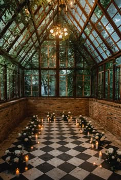 the inside of a building with candles and flowers