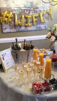 a table topped with champagne glasses filled with fruit