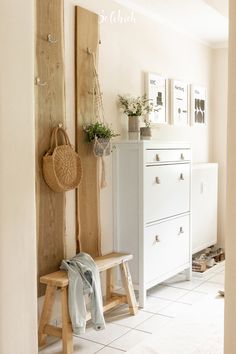 a wooden bench sitting next to a white dresser