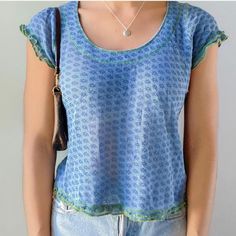 Look Your Absolute Best In The Free People's Garner Tee! Crafted From A Semi Sheer Floral Fabrication With Ruffle Trim, This Blue Top Has A Flattering Semi Relaxed Fit And A Dainty Scoop Neckline. Accented With Green Contrast Stitching For A Subtle, Yet Stylish Touch! Runs Small, Brand New, Never Worn. Blue Crew Neck Top With Ruffles, Light Blue Summer Tops For Layering, Light Blue Tops For Summer Layering, Blue Tops For Layering, Light Blue Casual Ruffled Top, Light Blue Casual Ruffle Top, Casual Light Blue Ruffled Tops, Trendy Blue Ruffled Tops, Trendy Blue Tops With Ruffles