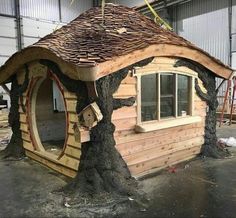 a house made out of logs and wood