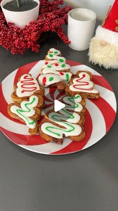 christmas cookies on a plate with santa's hat in the background