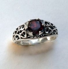 "You're beautiful A great design exposes sterling silver filigree ring with a deep red garnet stone set with prongs. (code- R2115) © 2011-2015, Artisanimpact Inc. All rights reserved. Construction and dimensions: Sterling silver, garnet Approximate diameter on top 7mm (0.27\") We can make any size, including quarter sizes. Please just indicate the requested size in the order. About our jewelry Artisanlook offers an exciting collection, designed and made by artisanimpact inc, especially for occas Ornate Ruby Ring With Intricate Design, Elegant Sterling Silver Ruby Ring With Birthstone, Elegant Ruby Promise Ring Stamped 925, Elegant Ruby Ring Stamped 925 For Promise, Garnet Rings With Intricate Design, Classic Garnet Rings With Intricate Design, Sapphire Ring In Sterling Silver With Intricate Design, Elegant Hallmarked Garnet Birthstone Ring, Ornate Round Garnet Rings