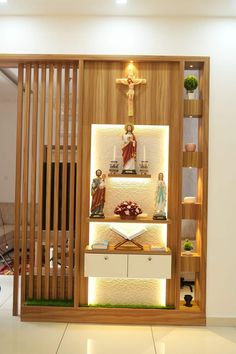 the inside of a room with shelves and statues on display in front of a crucifix