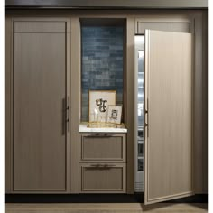 an open refrigerator door in a kitchen next to cabinets