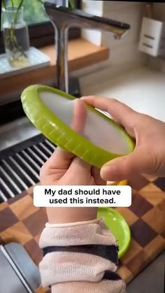 a person holding a green object in their hand with the caption'my dad should have used this instead '