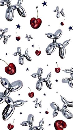 an image of some silver objects with red apples and stars around them on a white background