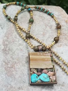 Imagine a distant horizon in the desert. Tan/cream stained glass is picturesque when combined with a foundation of unakite chips and turquoise nuggets. The 20" necklace includes African opal round beads, maizy and turquoise colored beads and copper metal beads. Southwestern or boho chic fans, this is for you. All materials are set in a 1.5"x1" stainless steel copper color bezel.  The necklace arrives in a violet burlap bag for easy gifting or protective storage.  All designs are one of a kind wearable pieces of art. I hope it brings the wearer as much joy as I had creating it. Earthy Turquoise Necklace With Natural Stones, Turquoise Bohemian Necklace With Rectangular Pendant, Bohemian Turquoise Necklace With Rectangular Pendant, Bohemian Turquoise Rectangular Necklace, Bohemian Turquoise Inlay Necklace Gift, Bohemian Turquoise Inlay Necklace As Gift, Stained Glass Necklace, Mosaic Stained, Stained Glass Mosaic