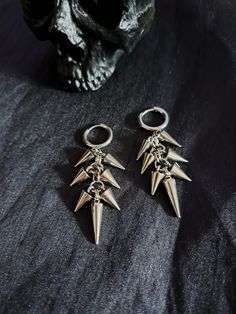 Spikes & rings galore perfectly layered on antique silver coloured earring hoops. ✦ 2.5" full drop. ✦ 0.5" hoop. ✦ Gauge stretcher tunnel friendly. ✦ Lead & nickel free ✦ Alloy metal. ✦ Comes gift wrapped with a little something extra! ~ BE ✦ 𝖄𝕺𝖀 ✦ NIQUE ✦ * Orders posted out daily worldwide. * Fashion/costume jewellery for those who dare to be different. * Follow me on Instagram, Twitter & Facebook for everything * heavymetal * goth * grunge * alternative * pagan * streetwear * metalhead * v Silver Metal Emo Style Earrings, Silver Metal Emo Earrings, Punk Style Metal Cartilage Earrings For Party, Metal Hoop Earrings For Streetwear, Emo Style Pierced Metal Earrings, Nickel Free Silver Emo Earrings, Nickel-free Silver Emo Earrings, Silver Nickel-free Emo Earrings, Gothic Pierced Jewelry For Concerts