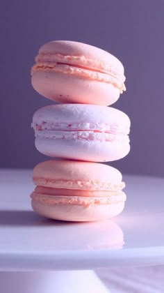 three pink macaroons stacked on top of each other