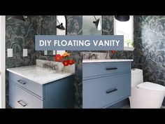 a bathroom with blue and white wallpaper has a sign that says diy floating vanity