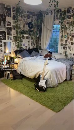 a bed room with a guitar on the floor