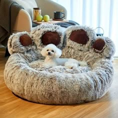 a dog is sitting in a bed made to look like it has four paws on it