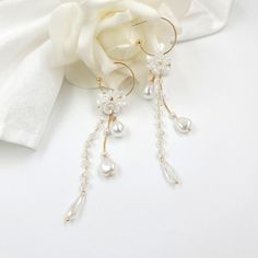 "Beautiful wedding flower earrings - dangle and drop earrings The earrings are made of artificial flowers, pearls, chains, and other trinkets used for arranging. #1   - Total 4.5\" long - 1\" (20mm) outer diameter C post Hoop - 0.4\" Flowers - 0.4\" W x 0.6\" H teardrop pearl - 0.65\" long faceted crystal bead #2  - Total 3.15\" long - 1\" (20mm) outer diameter C post Hoop - 0.4\" Flowers" Gold Hoop Earrings With Flower Charm For Wedding, Dangle Earrings With Flower Charm For Party, Party Flower Charm Dangle Earrings, Party Dangle Earrings With Flower Charm, Elegant Flower Beaded Earrings For Wedding, Flower Shaped Earrings With Ear Wire For Wedding, Delicate Pearl Charm Flower Earrings For Wedding, Floral Pearl Charm Earrings For Wedding, Dangle Earrings With Flower Decoration For Party