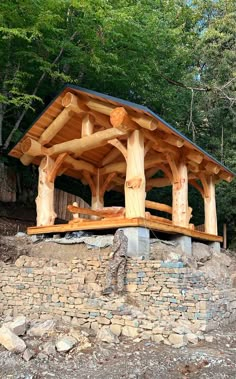 a wooden structure sitting on top of a pile of rocks