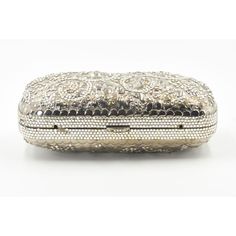 Elegant Judith Leiber silver metal and crystal oblong evening bag clutch featuring a scrolling foliage flower design on a silver - toned metal bag.  The hardware is silver.  It has a silver leather interior with a silver shoulder strap that can be folded inside when you want to wear it as a clutch.  There is a circle that folds out to hold a tassel, but it is no longer there.  Labeled ‘Judith Leiber/New York’ in the interior. 5.5” W x 3” H x 1.5” D  A similar one sold at Chrisities from Joan Riv Silver Evening Bag With Rectangular Case Shape, Silver Evening Bag Rectangular Case, Designer Evening Bag With Silver-tone Hardware For Formal Events, Luxury Formal Clutch With Silver-tone Hardware, Silver Clutch With Silver-tone Hardware For Events, Luxury Silver Clutch, Designer Silver Clutch For Formal Events, Designer Silver Clutch For Formal Occasions, Elegant Engraved Gold Bags