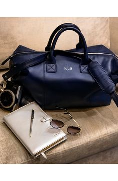 The ideal size for overnight trips, this handsome duffle bag is built from pebble-grain American nappa leather for exceptional appeal. Top zip closure Top carry handles; adjustable shoulder strap Interior zip pockets Leather Imported Luxury Navy Leather Satchel, Modern Leather Duffle Bag For Weekend Trips, Modern Blue Duffle Bag For Travel, Luxury Bags For Weekend Trips With Smooth Grain, Luxury Duffle Bag With Zipper For Overnight Trips, Classic Textured Leather Duffle Bag For Travel, Luxury Duffle Bag For Overnight Trips With Zipper Closure, Luxury Duffle Bag With Zipper Closure For Overnight Trips, Luxury Duffle Bag Tote With Zipper Closure