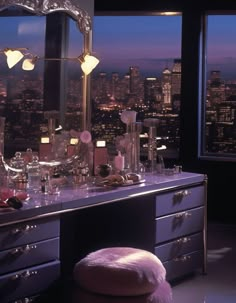 a vanity in front of a large window overlooking the city