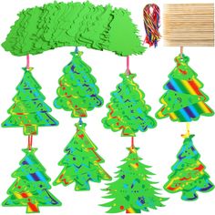 christmas tree cutouts are hanging from clothes pins