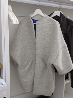 an open jacket hanging on a clothes rack