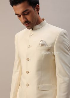 Designer White Nehru Jacket With Cutdana, Elegant Cream Kurta With Cutdana Detailing, Elegant Cream Kurta With Cutdana, Elegant Ceremonial Suits For Festive Occasions, Ceremonial Festive Elegant Suits, Elegant Fitted Bandhgala For Ceremonial Occasions, Off White Cutdana Wedding Sets, Designer White Raw Silk Sherwani, Designer Lehenga With Resham Embroidery For Wedding