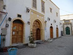 an old building with wooden doors and windows