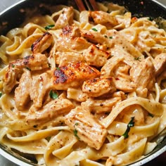 pasta with chicken and spinach in a skillet