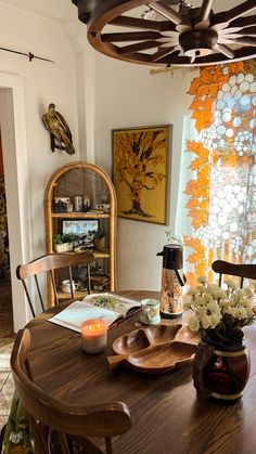 a dining room table with plates and flowers on it