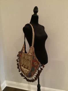 "Boho shoulder bag. Cotton bag with shear material on outside that is embroidered. Colors are brown, gold, and touches of deep blue and peach.  The opposite side is similar but also has some touches of red and green embroidery.  Unique and elegant piece. 15\" height, 18\" length" Travel Embroidered Beige Shoulder Bag, Embroidered Beige Shoulder Bag For Travel, Brown Embroidered Rectangular Bag, Vintage Embroidered Shoulder Bag For Festivals, Brown Shoulder Bag With Long Handle, Brown Embroidered Rectangular Satchel, Festival Brown Shoulder Bag With Removable Pouch, Embroidered Brown Rectangular Satchel, Multicolor Embroidered Shoulder Bag With Adjustable Strap